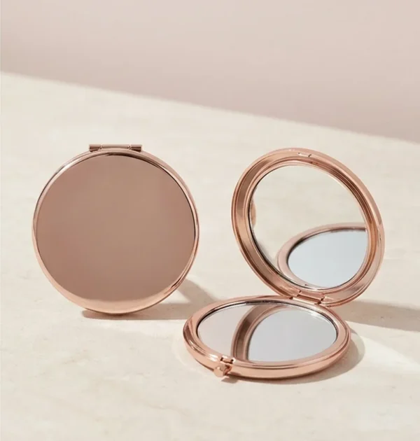 Round rose-gold compact mirror shown open and closed.