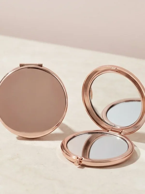 Rose Gold Compact Mirror Round rose-gold compact mirror shown open and closed.