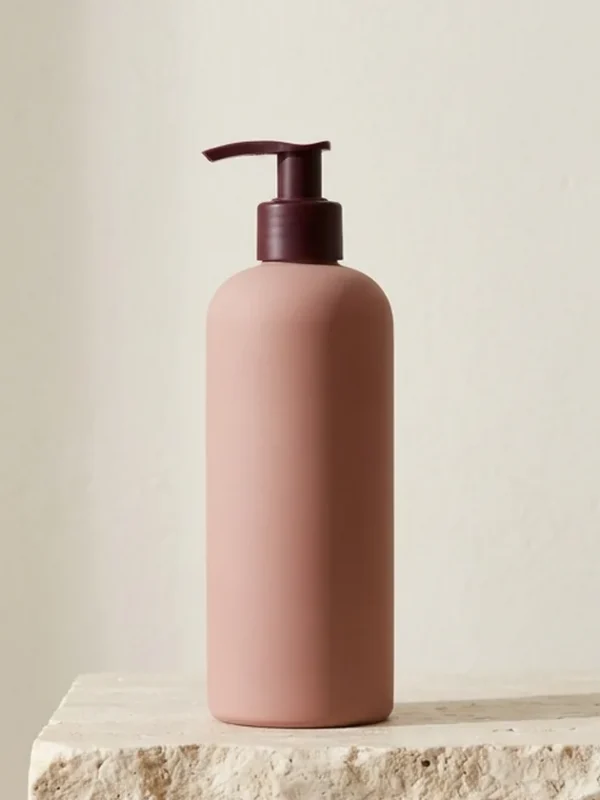 Silk Root Daily Conditioner – 300 ml Blush conditioner bottle with a burgundy pump on a stone plinth.