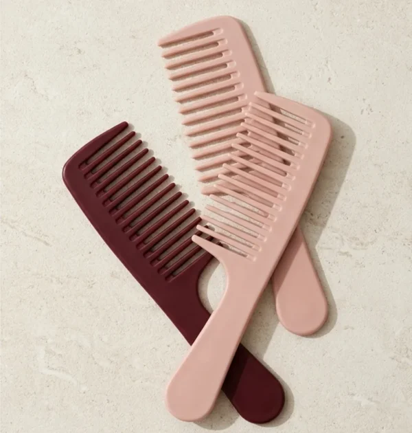 Rose & Burgundy Wide-Tooth Comb Set – 3 Pieces Three wide-tooth combs in blush and burgundy on pale stone.
