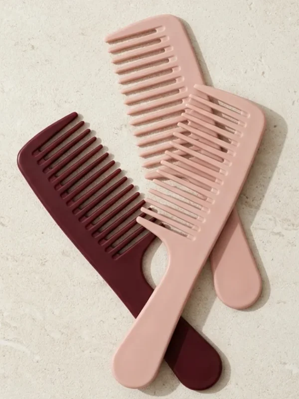 Rose & Burgundy Wide-Tooth Comb Set – 3 Pieces Three wide-tooth combs in blush and burgundy on pale stone.